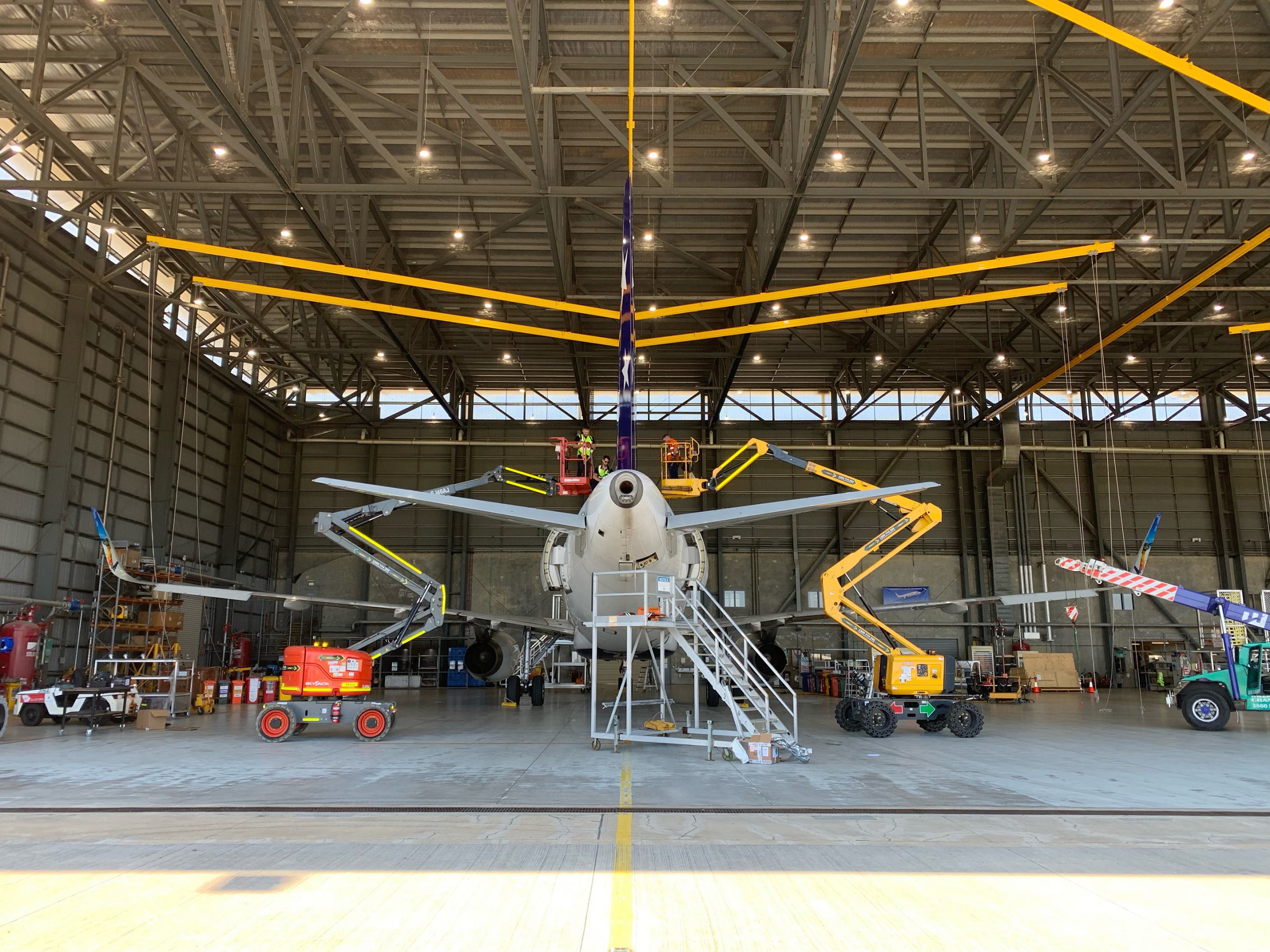 two boom lifts operating on a plane